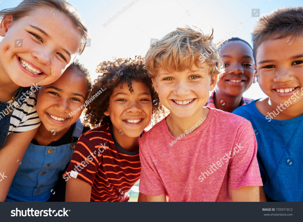 stock-photo-close-up-of-pre-teen-friends-in-a-park-smiling-to-camera-735971812 - Restore American Schools