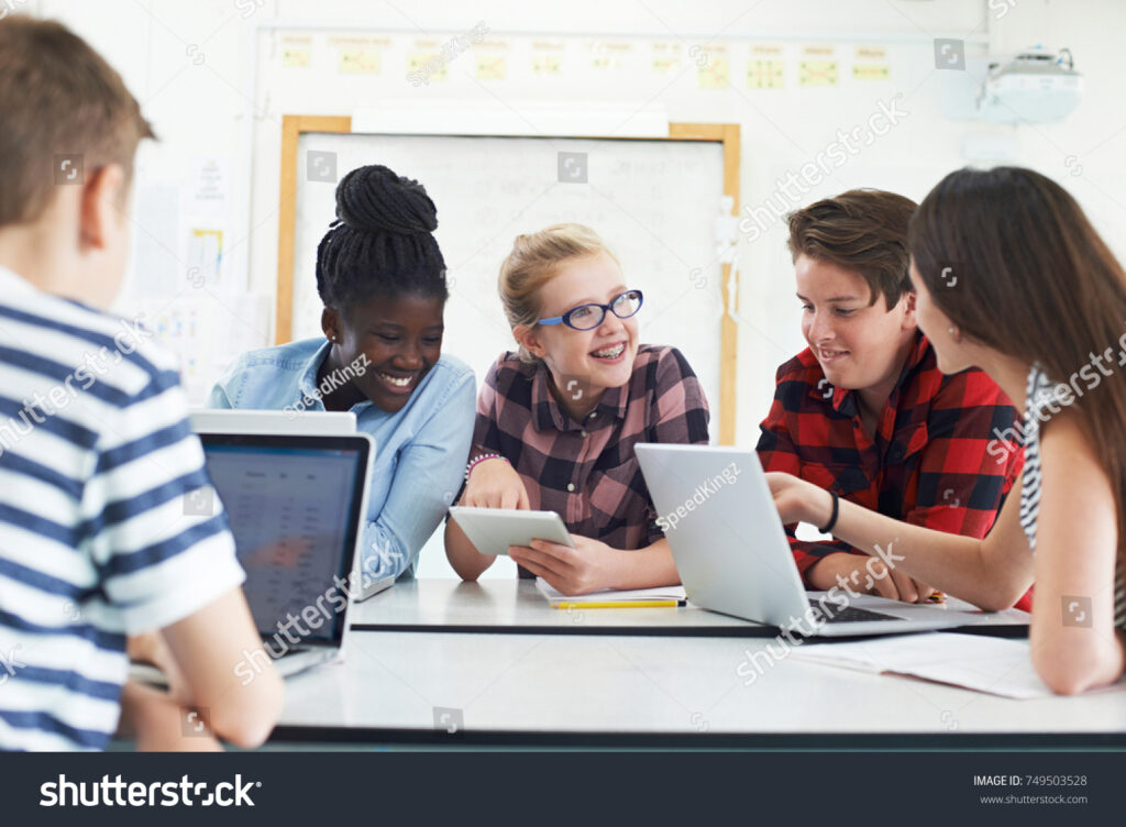 stock-photo-group-of-teenage-students-collaborating-on-project-in-it-class-749503528 - Restore American Schools