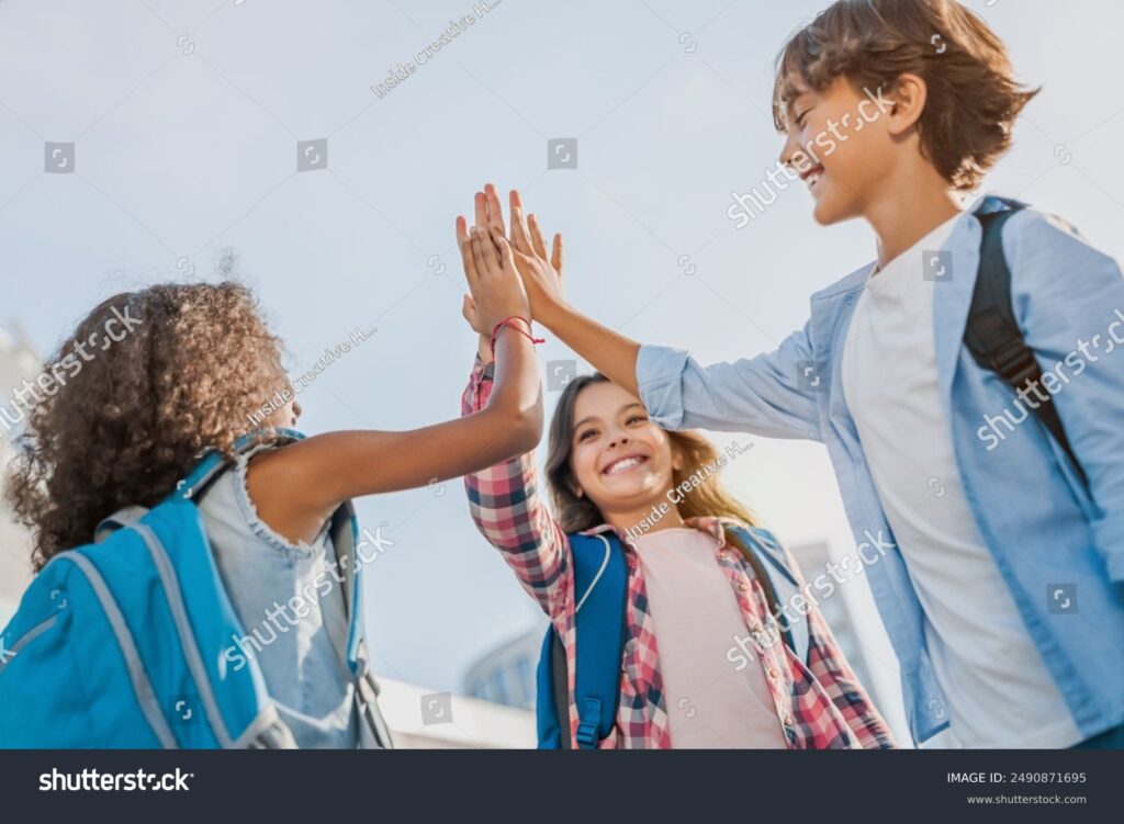 stock-photo-happy-children-giving-high-five-each-other-standing-near-school-outdoors-primary-education-2490871695 - Restore American Schools